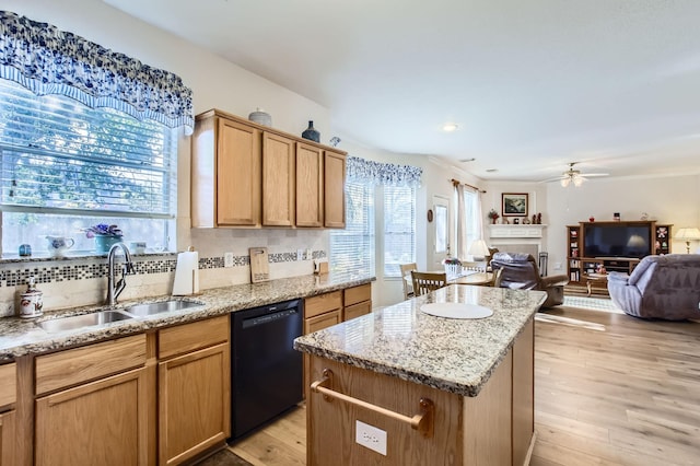 kitchen featuring sink, tasteful backsplash, a center island, dishwasher, and light hardwood / wood-style floors