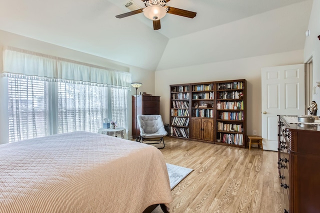 bedroom featuring ceiling fan, sink, vaulted ceiling, and light wood-type flooring