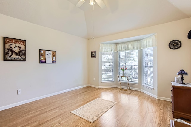 empty room with vaulted ceiling, light hardwood / wood-style floors, and ceiling fan