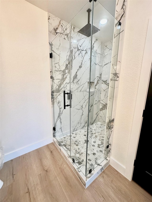 bathroom with wood-type flooring and walk in shower