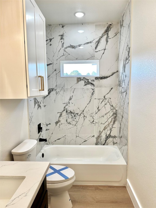 full bathroom featuring wood-type flooring, toilet, vanity, and bathing tub / shower combination