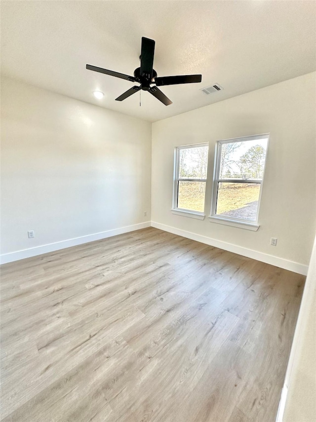 spare room with ceiling fan and light hardwood / wood-style flooring