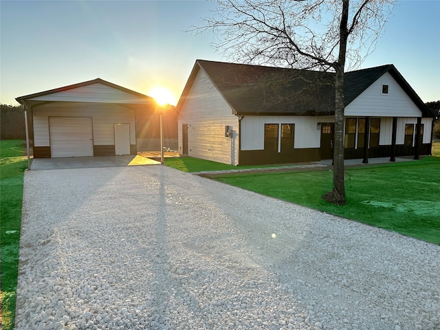 view of front of property with a garage, a yard, and a carport