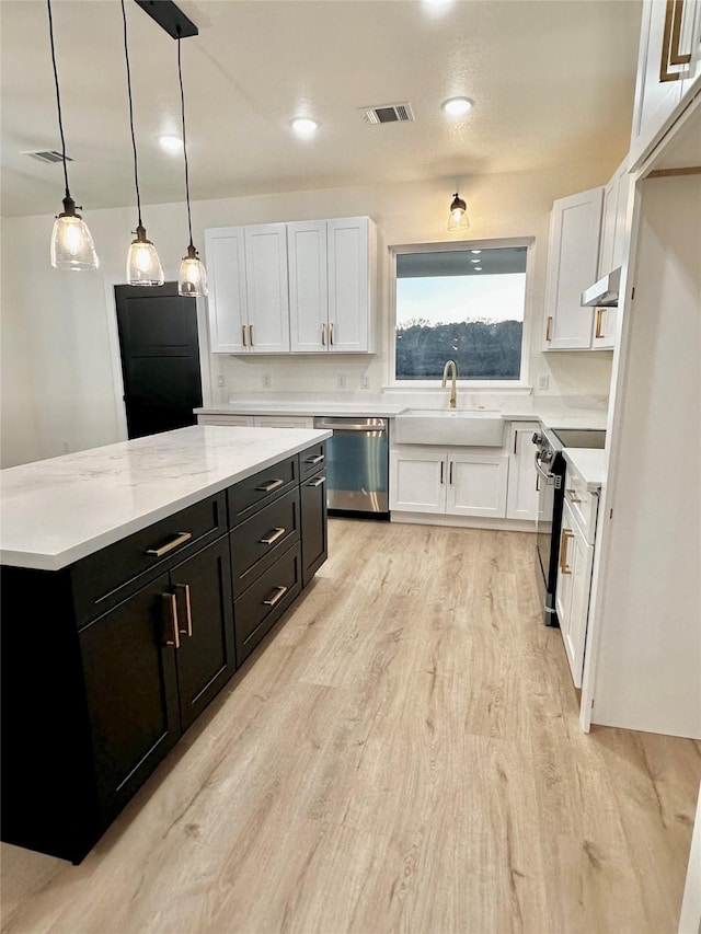 kitchen featuring range with electric stovetop, white cabinets, dishwasher, and hanging light fixtures