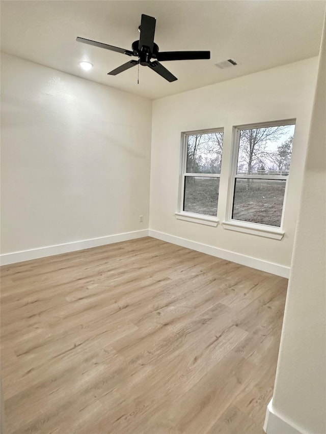 empty room with light wood-type flooring and ceiling fan