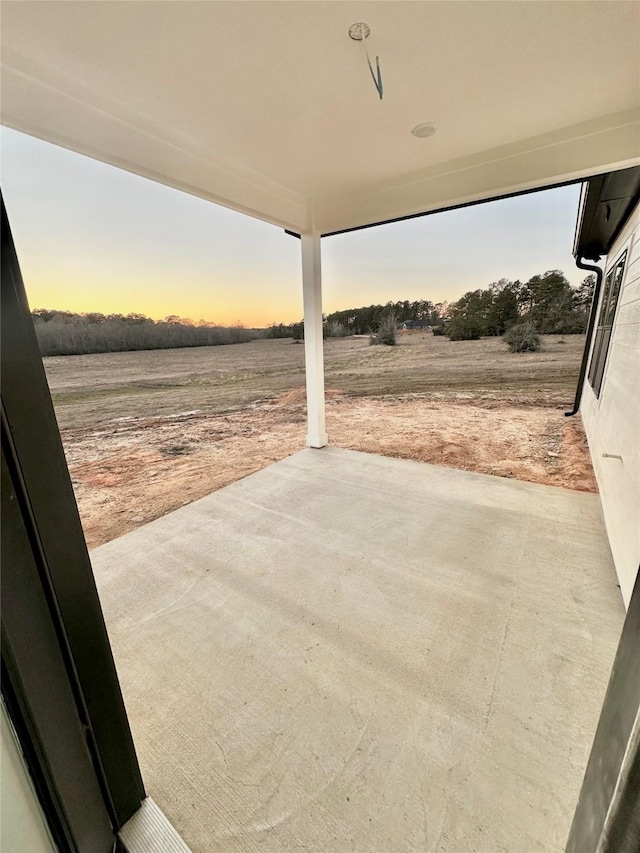 patio terrace at dusk with a rural view