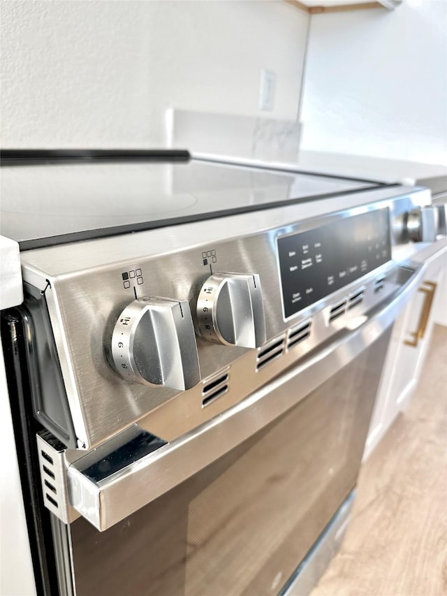 interior details with stainless steel range with electric stovetop