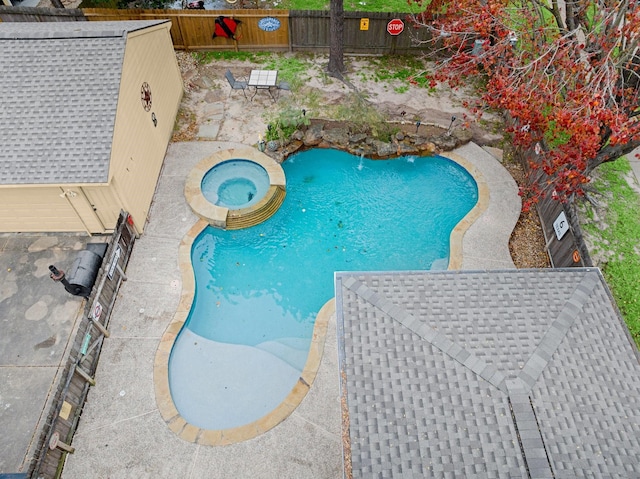 view of pool with an in ground hot tub