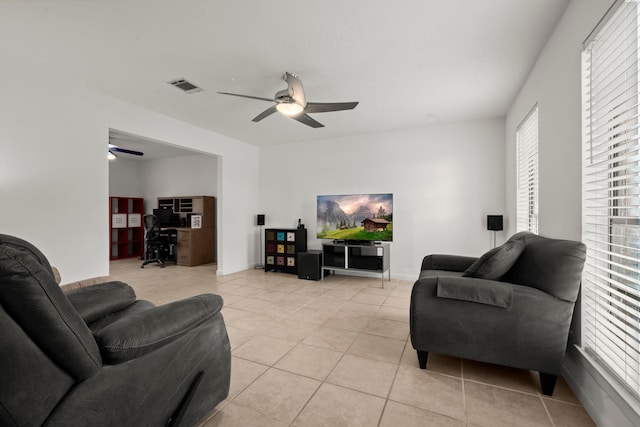 tiled living room with ceiling fan