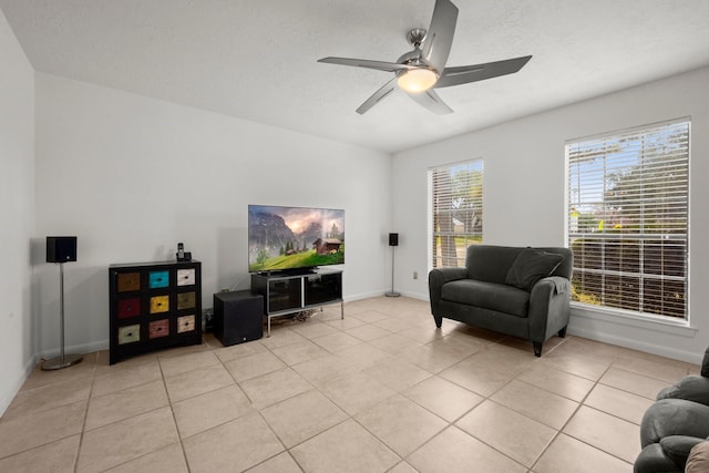 living room featuring light tile patterned floors and ceiling fan