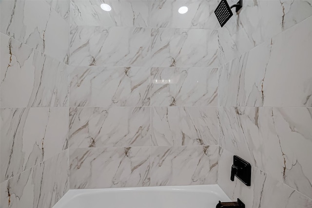 interior details featuring bathtub / shower combination