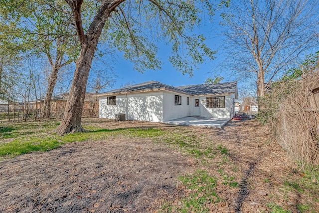 rear view of house with a patio and central AC unit