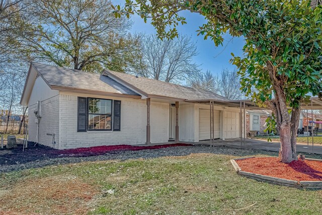 ranch-style house with a carport and a front lawn