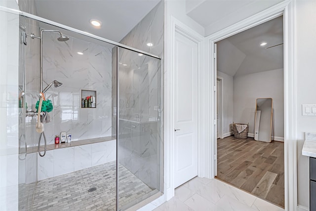 bathroom featuring a shower with shower door, hardwood / wood-style floors, and vanity