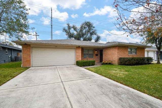 ranch-style home with a garage, central AC, and a front lawn