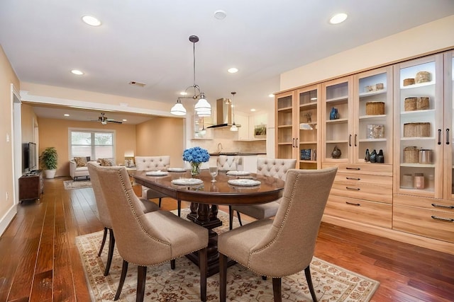 dining room with sink, ceiling fan, and dark hardwood / wood-style flooring