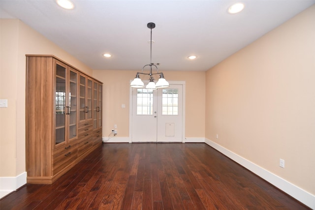 unfurnished dining area featuring french doors and dark wood-type flooring