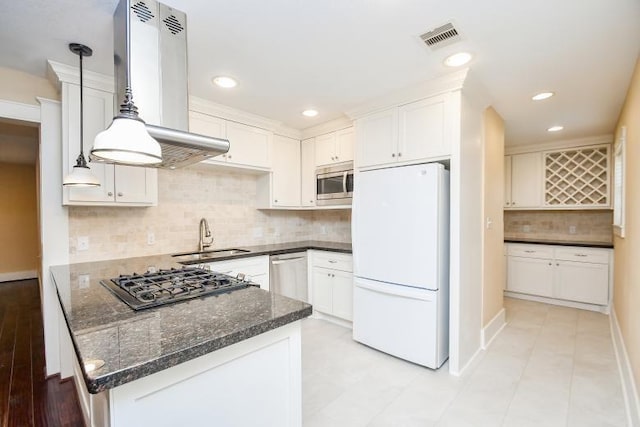 kitchen featuring appliances with stainless steel finishes, decorative backsplash, sink, decorative light fixtures, and white cabinets