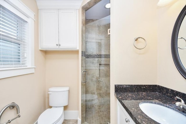 bathroom featuring toilet, walk in shower, and vanity