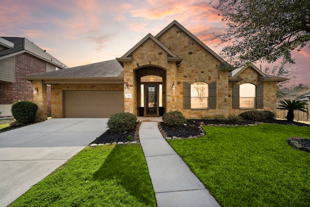 view of front facade featuring a garage, a front lawn, concrete driveway, and roof with shingles