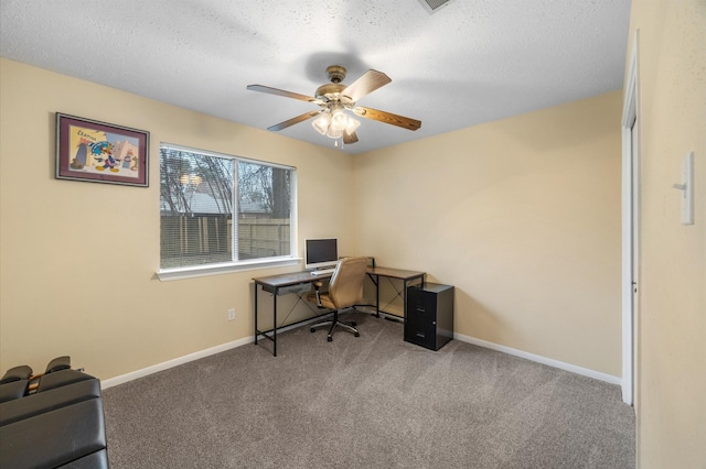 home office with baseboards, carpet, a ceiling fan, and a textured ceiling