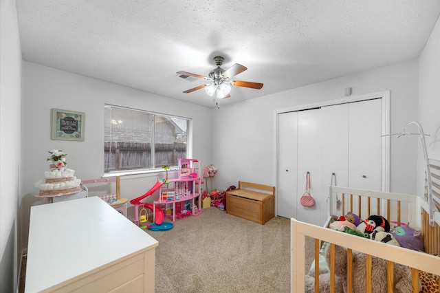 bedroom with a closet, ceiling fan, a textured ceiling, and carpet