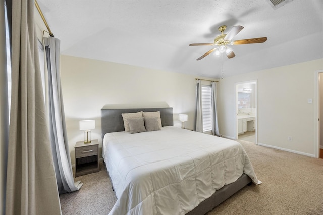 carpeted bedroom featuring a textured ceiling, ceiling fan, and ensuite bathroom