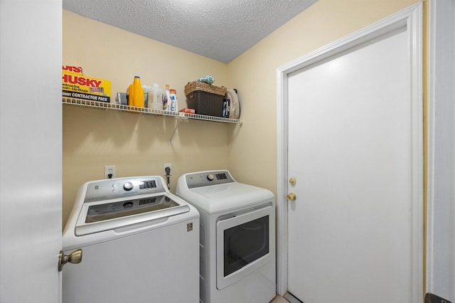 laundry room featuring independent washer and dryer and a textured ceiling