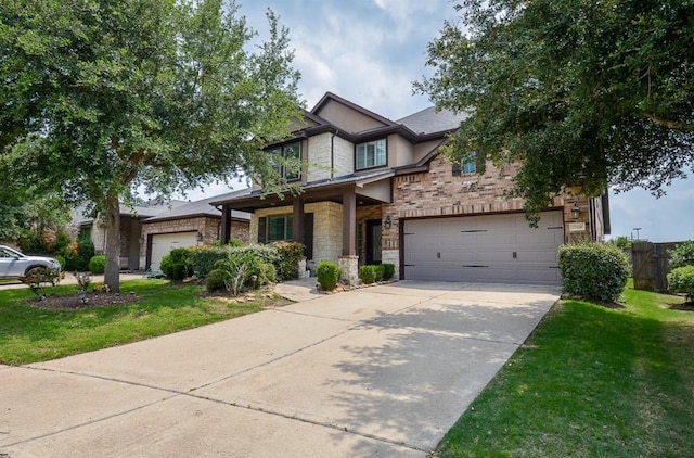 craftsman inspired home featuring stone siding, a front lawn, and driveway