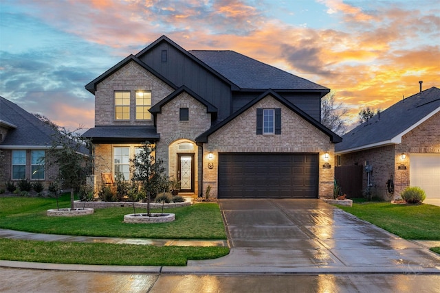 view of front of property featuring a garage and a yard