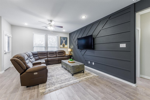 living room featuring light hardwood / wood-style floors and ceiling fan