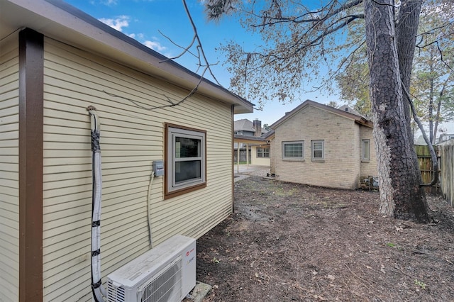 view of side of home with ac unit