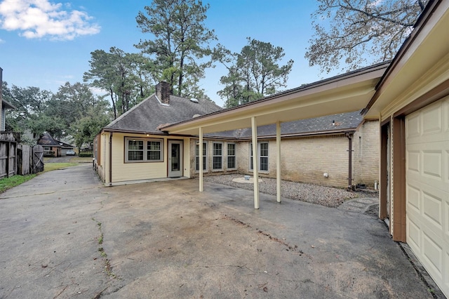 rear view of house featuring a garage