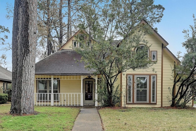 view of front of home featuring covered porch and a front lawn