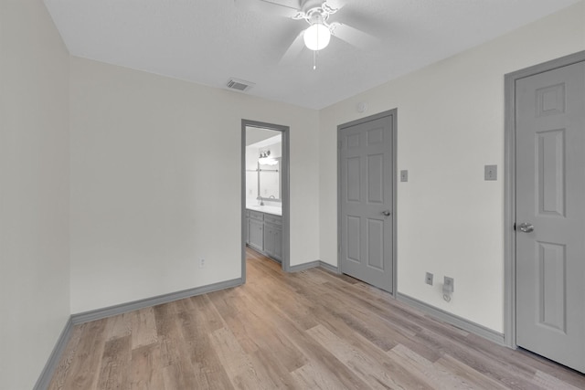 empty room featuring ceiling fan and light hardwood / wood-style flooring