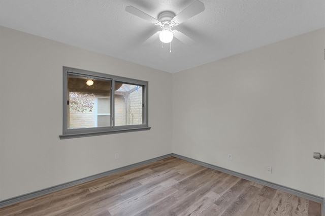 unfurnished room featuring ceiling fan, a textured ceiling, and light wood-type flooring