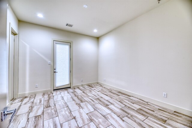 1504 Anita St, Houston, TX 77004 - spare room featuring baseboards, light wood-style flooring, visible vents, and recessed lighting