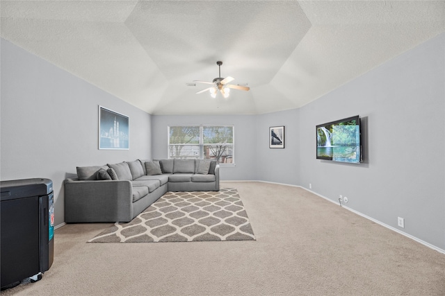 carpeted living room featuring ceiling fan, lofted ceiling, and a textured ceiling