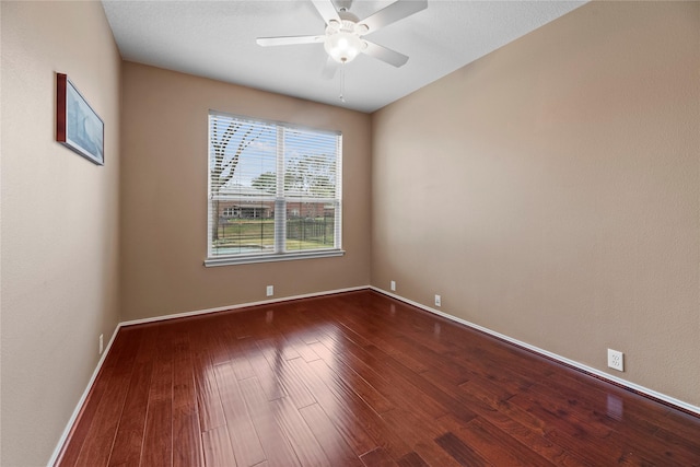 empty room with hardwood / wood-style flooring and ceiling fan