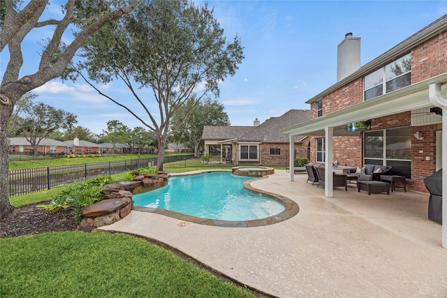 view of pool featuring an outdoor living space, a patio, and an in ground hot tub