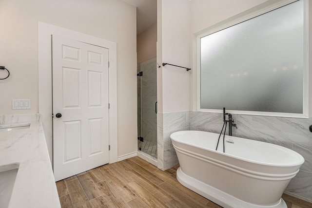 bathroom featuring shower with separate bathtub and vanity