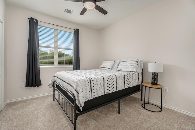 bedroom featuring light colored carpet and ceiling fan