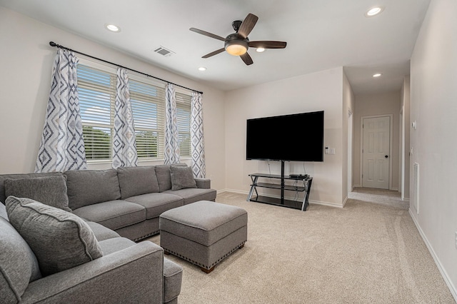 carpeted living room featuring ceiling fan