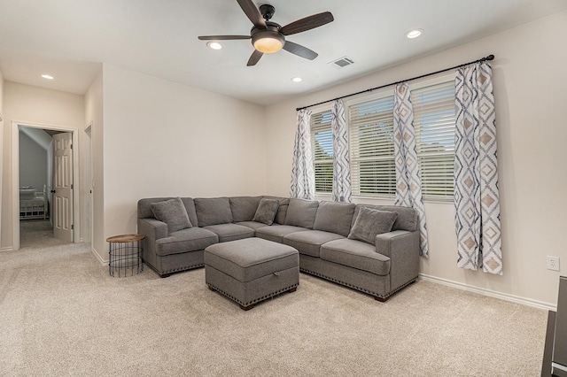 living room with light colored carpet and ceiling fan