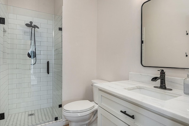 bathroom with vanity, toilet, and an enclosed shower