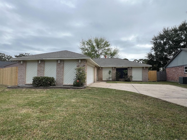 ranch-style house featuring central AC unit, a garage, and a front yard