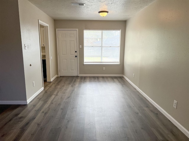 interior space featuring dark hardwood / wood-style floors and a textured ceiling