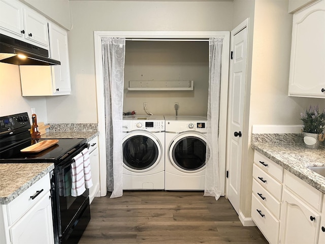 laundry room with dark hardwood / wood-style floors and washer and dryer