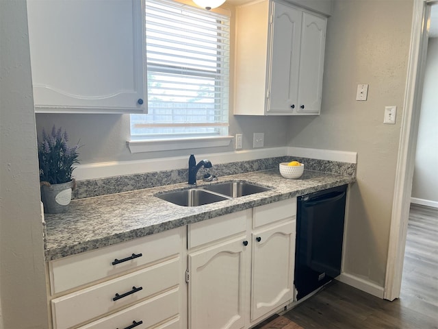 kitchen with black dishwasher, sink, and white cabinets