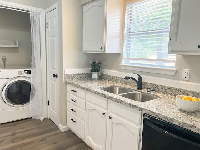 laundry area with a healthy amount of sunlight, washer / dryer, sink, and dark wood-type flooring